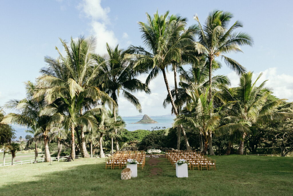 Wide landscape view of Kualoa Ranch mountains and ceremony setup for a luxury Oʻahu wedding