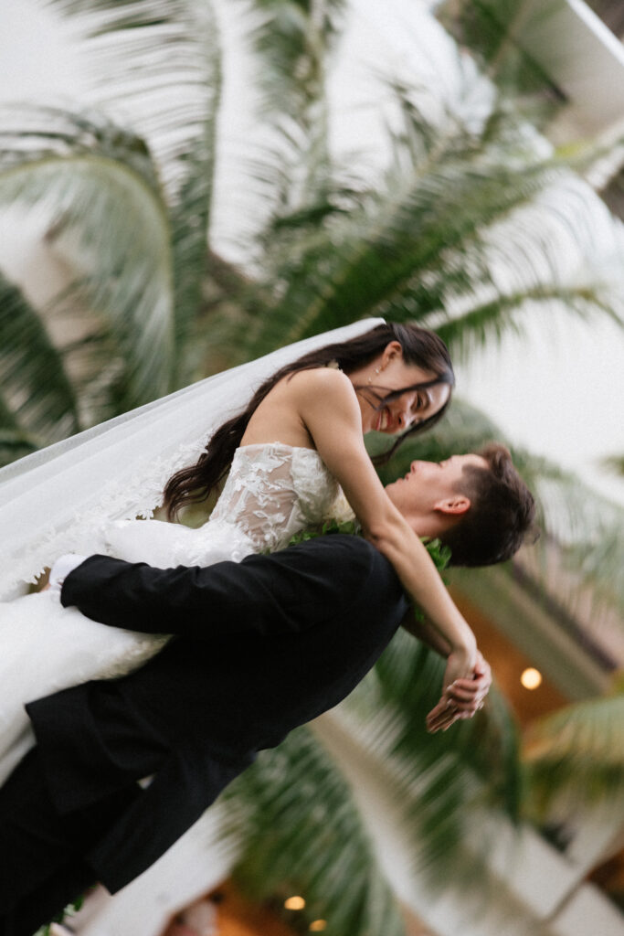 Couple embracing before their Halekulani wedding ceremony.
