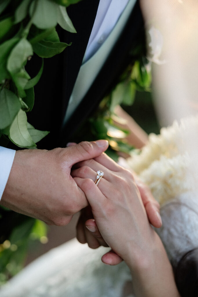 Newlyweds embracing during golden hour in Waikīkī.